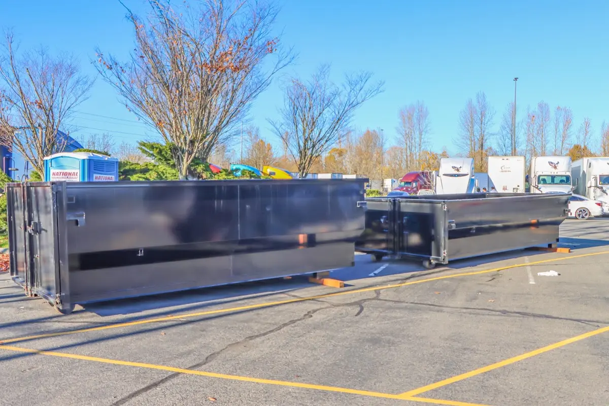 Professional dumpster rental service with roll-off container on residential driveway in Bullhead City